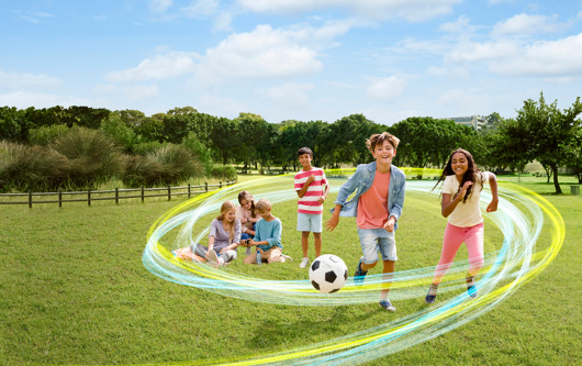 Kids playing soccer on a field